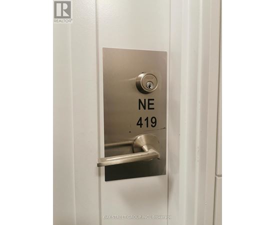 A door handle with the label NE 419 on it.