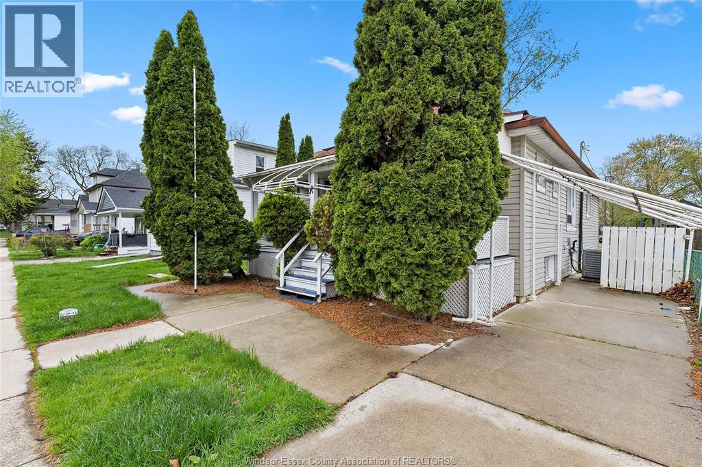 A realtor photo of a residential area with a house and trees.