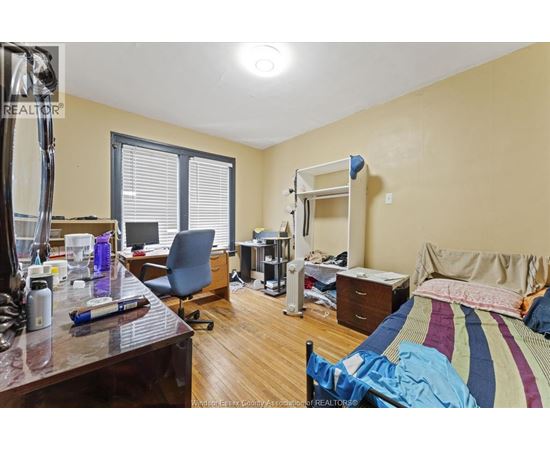 A bedroom with a bunk bed and a desk with a computer.