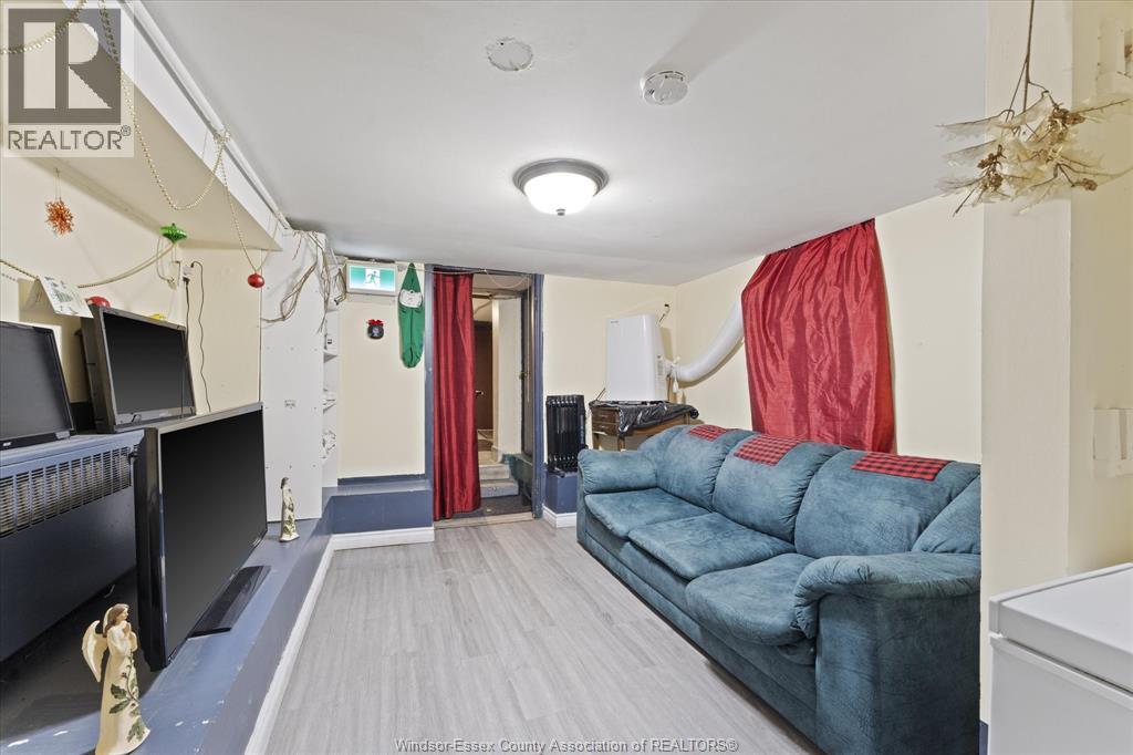 A living room with a blue couch and a television.