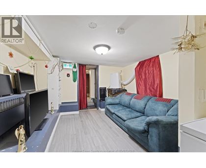 A living room with a blue couch and a television.