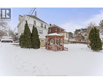 A house with a snow-covered front yard and a gazebo.