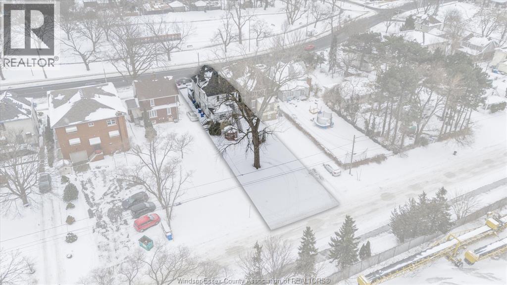 A snowy landscape with a house and trees.