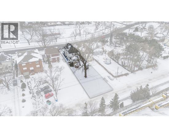 A snowy landscape with a house and trees.