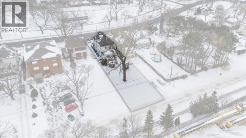 A snowy landscape with a house and trees.