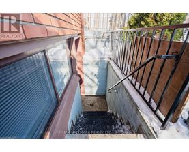 A view from a window looking down a snowy staircase.