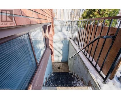 A view from a window looking down a snowy staircase.