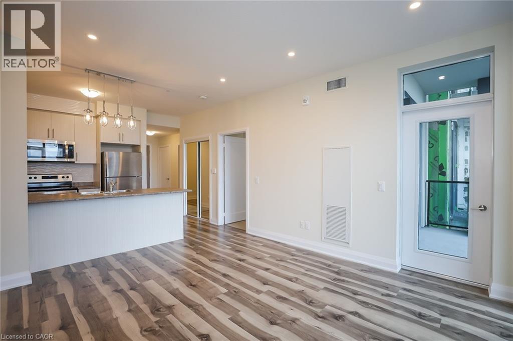 A spacious room with a wooden floor and white walls.