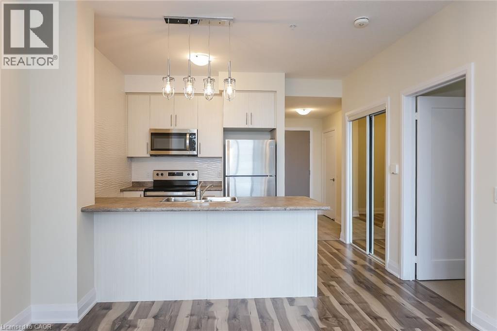 A modern kitchen with a white countertop and a microwave above it.