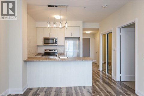 A modern kitchen with a white countertop and a microwave above it.
