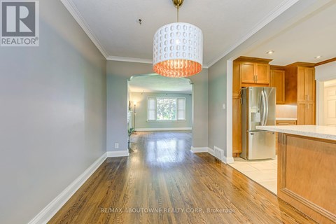 A spacious kitchen with wooden cabinets and a refrigerator.