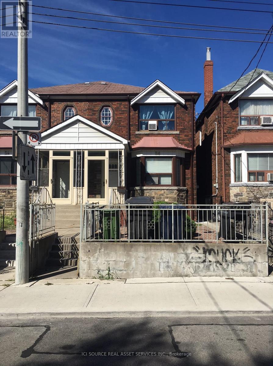 A house with a gate and a sign that says "REALTOR".