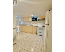 A kitchen with white appliances and a white refrigerator.