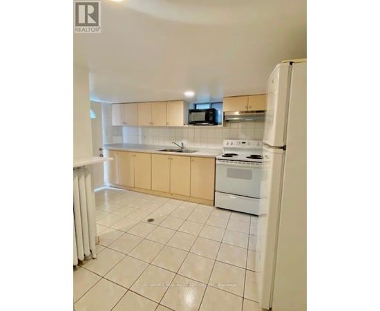 A kitchen with white appliances and a white refrigerator.