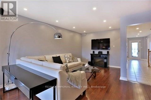 A living room with a white couch and a black coffee table.