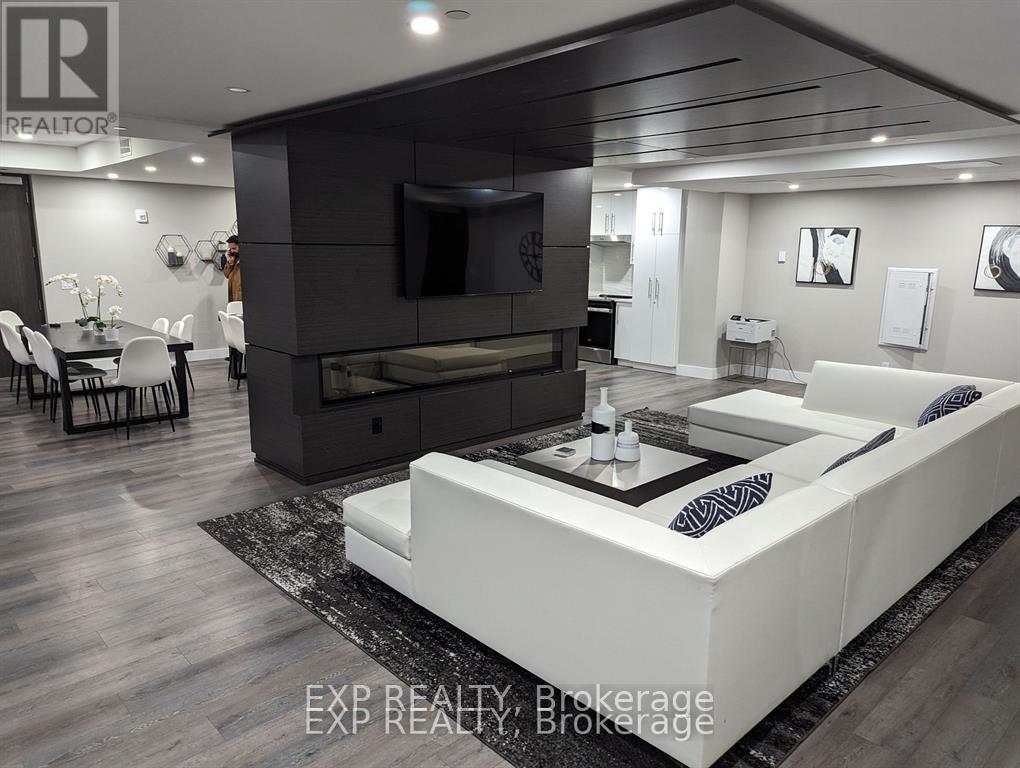 A modern living room with a white sofa and a black entertainment center.