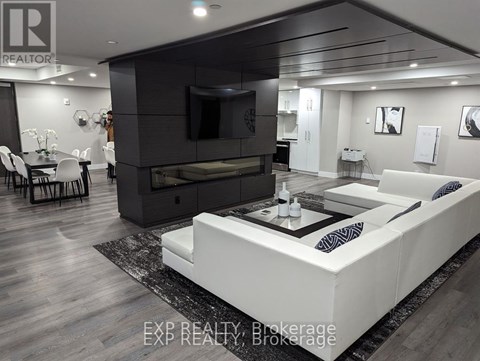 A modern living room with a white sofa and a black entertainment center.
