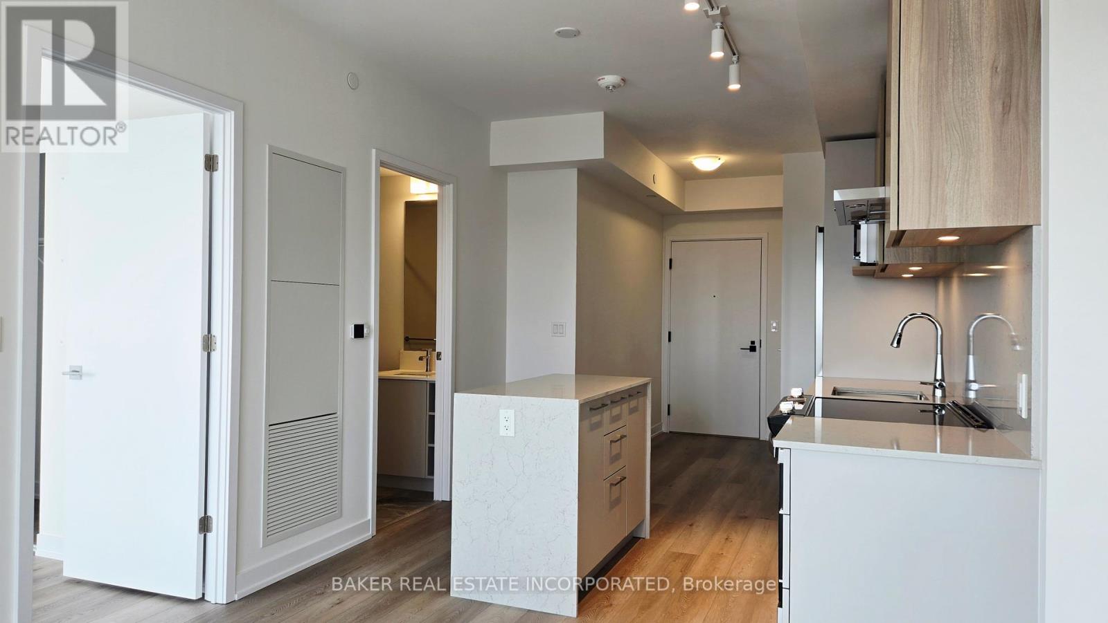 A white kitchen with a sink and cabinets.