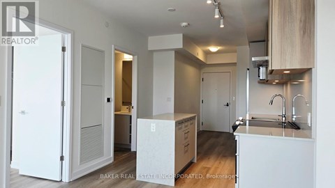 A white kitchen with a sink and cabinets.