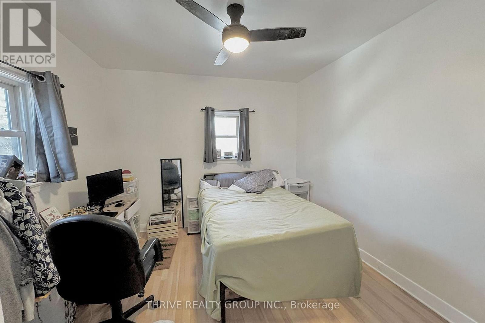 A bedroom with a bed, desk, and chair.