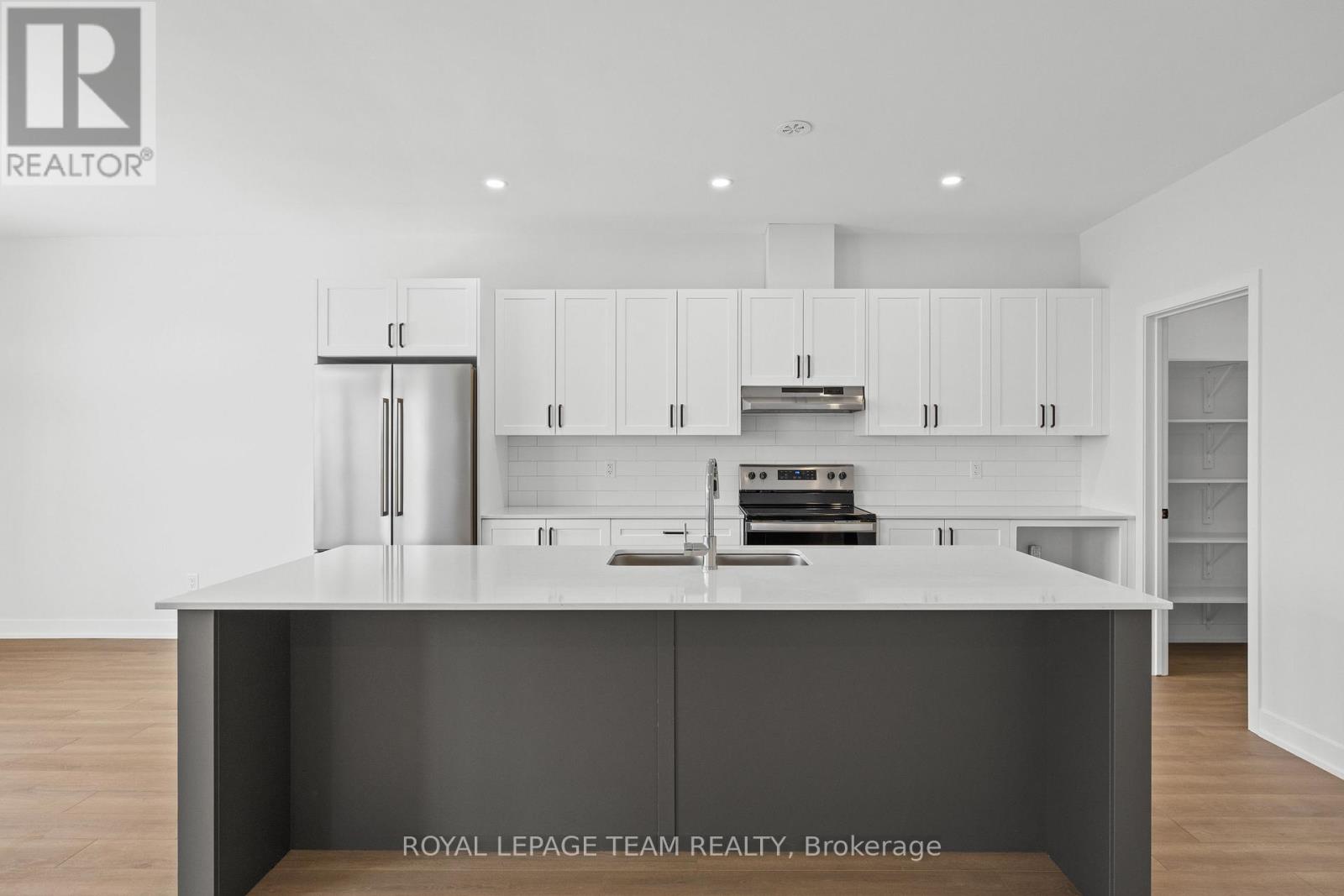 A modern kitchen with white cabinets and a central island.