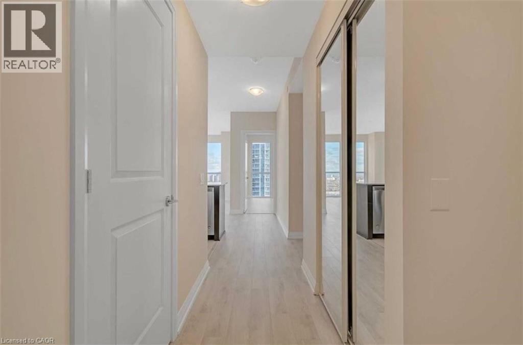 A hallway with a door on the left and a window on the right.