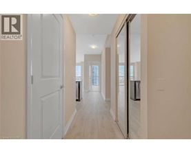 A hallway with a door on the left and a window on the right.