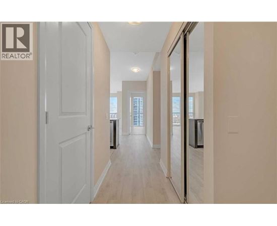 A hallway with a door on the left and a window on the right.