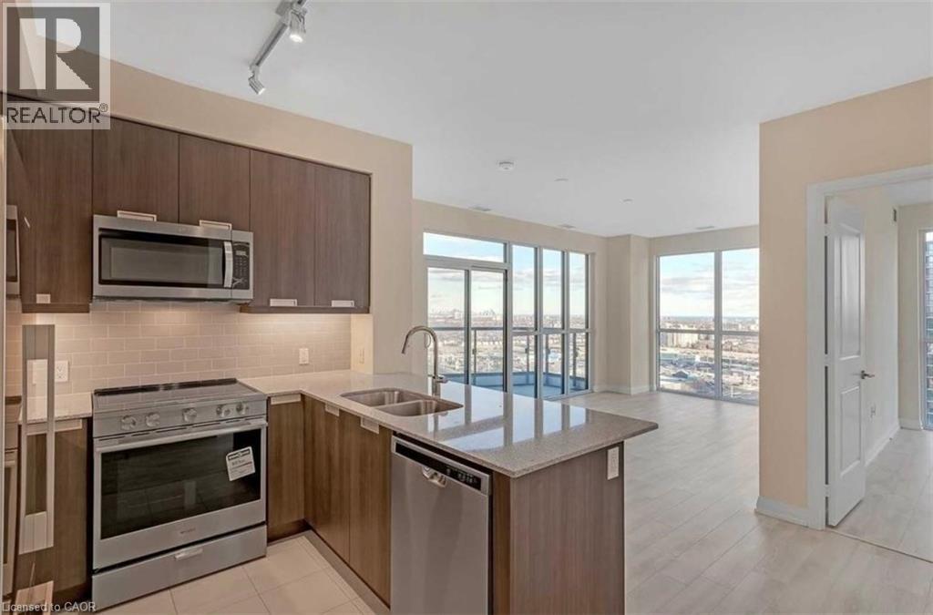 A modern kitchen with a stainless steel oven and microwave.