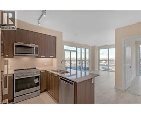 A modern kitchen with a stainless steel oven and microwave.