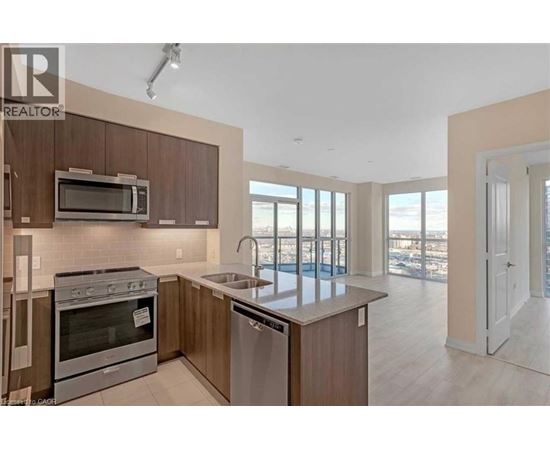 A modern kitchen with a stainless steel oven and microwave.