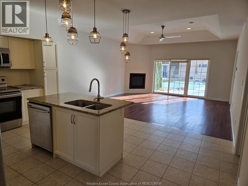 A kitchen with a sink and a microwave.