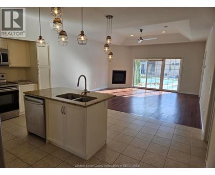 A kitchen with a sink and a microwave.