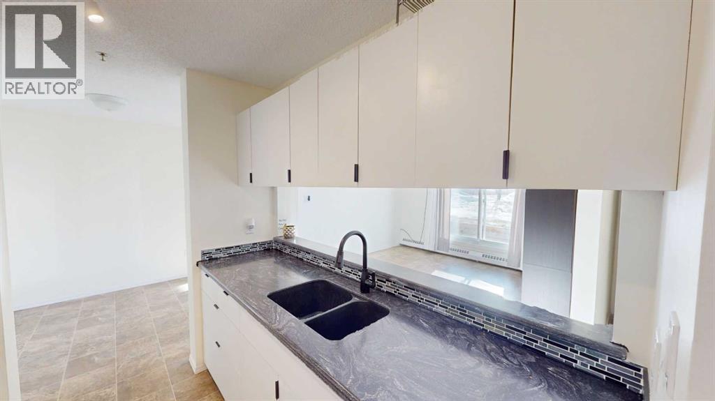 A kitchen with a sink and cabinets.