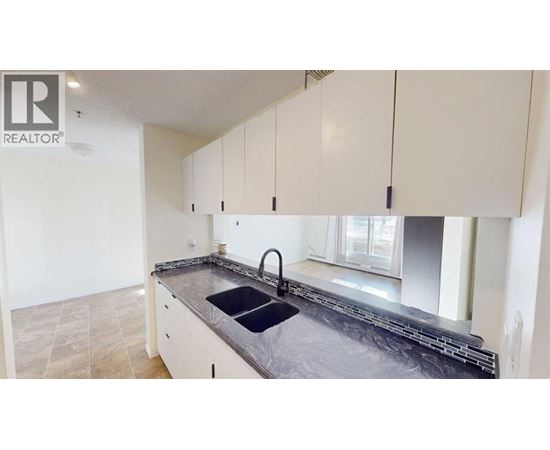 A kitchen with a sink and cabinets.