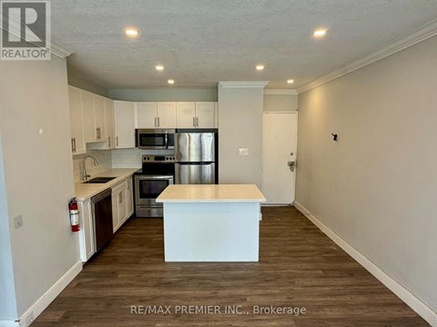 A kitchen with a white island in the middle of the room.