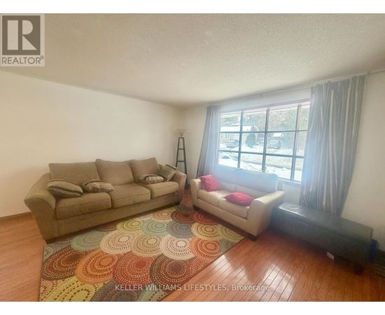 A living room with a couch and a chair.
