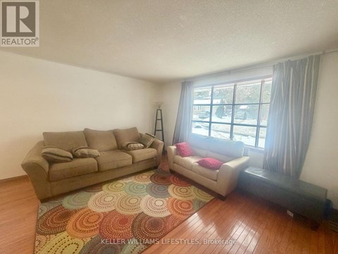A living room with a couch and a chair.