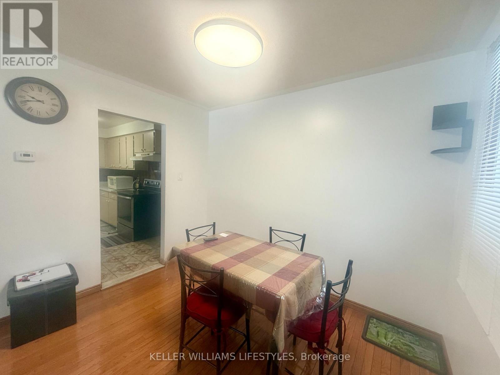A dining room with a table and chairs.