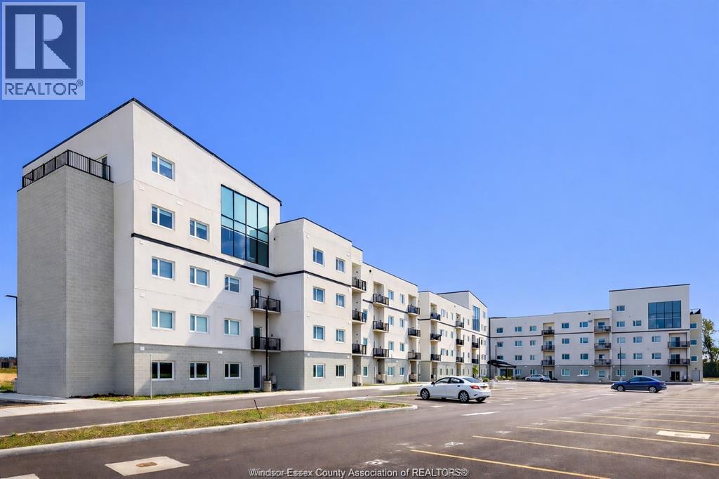 A large white building with a car parked in front of it.