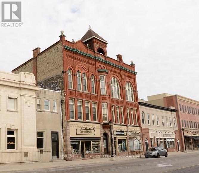 A street view of a town with a building that has a sign that says "Oriental Union".