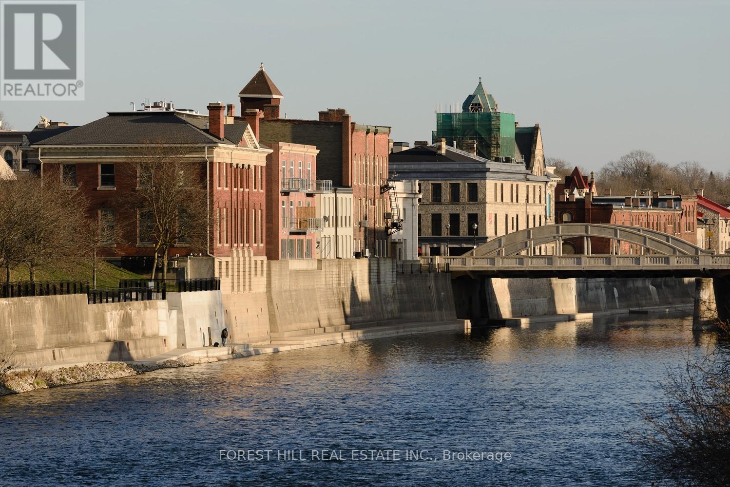 A cityscape with a river and a bridge.