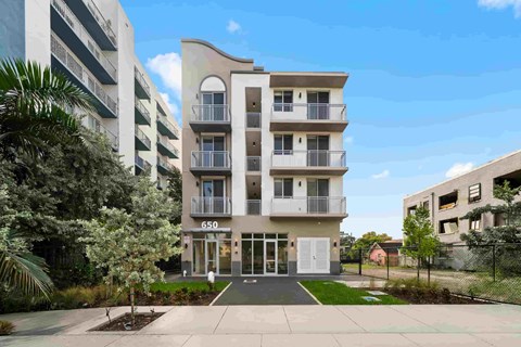 A modern apartment building with the number 650 on the front.