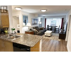 A kitchen with granite countertops and a dining area with a table and chairs.