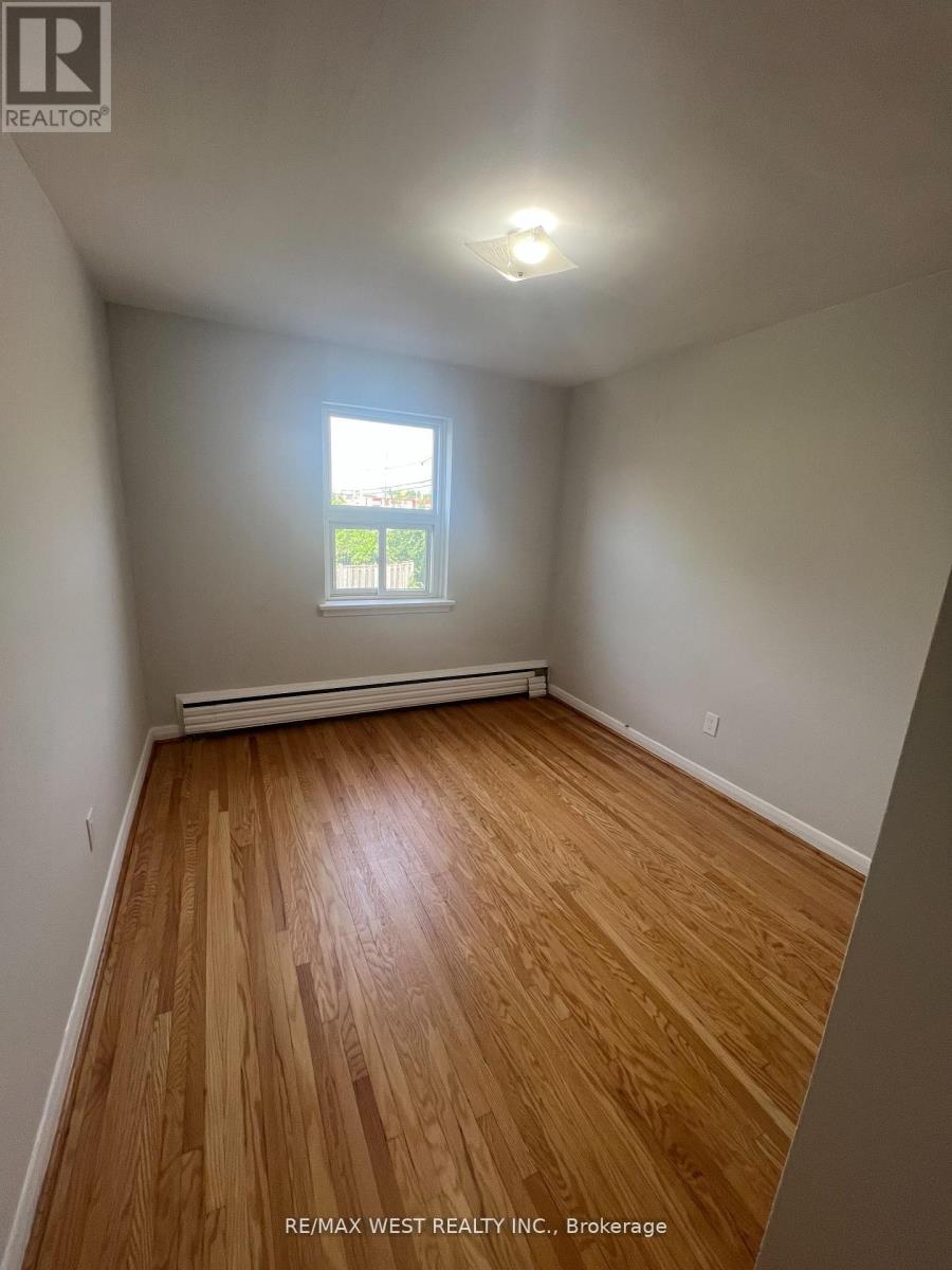 A room with wooden flooring and a window.