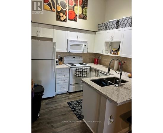A kitchen with white cabinets and a granite counter top.