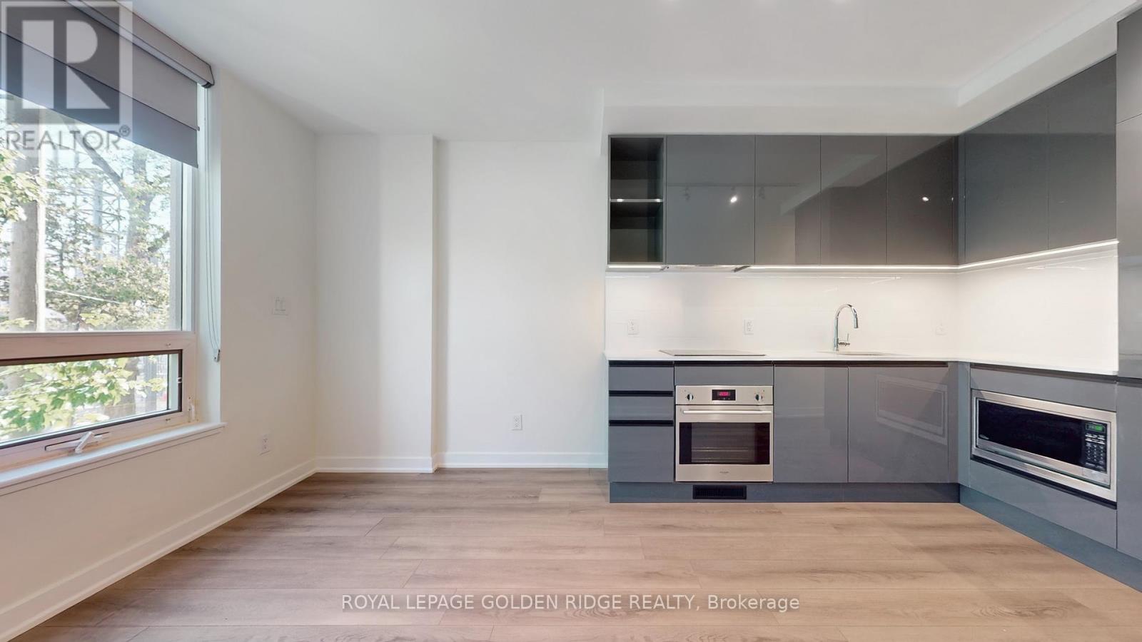A kitchen with a white oven and microwave.