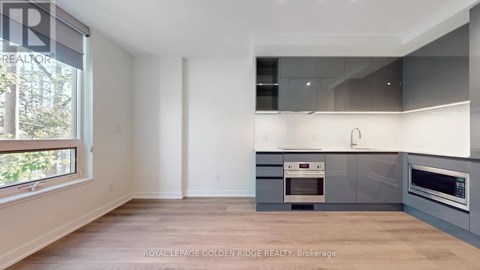 A kitchen with a white oven and microwave.