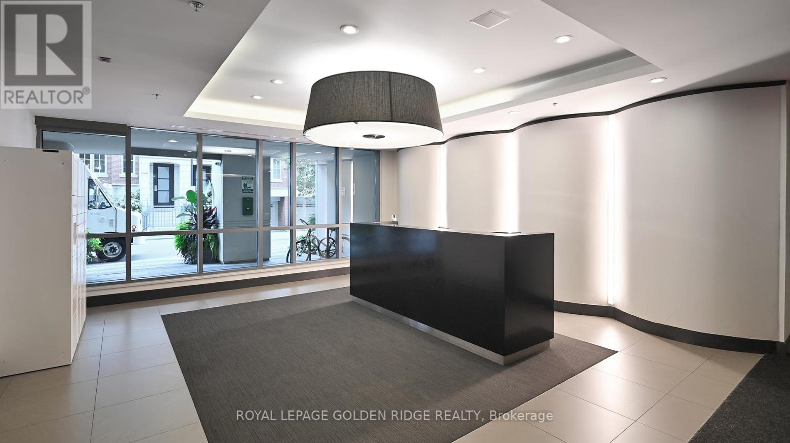 A black reception desk in a well-lit office space.