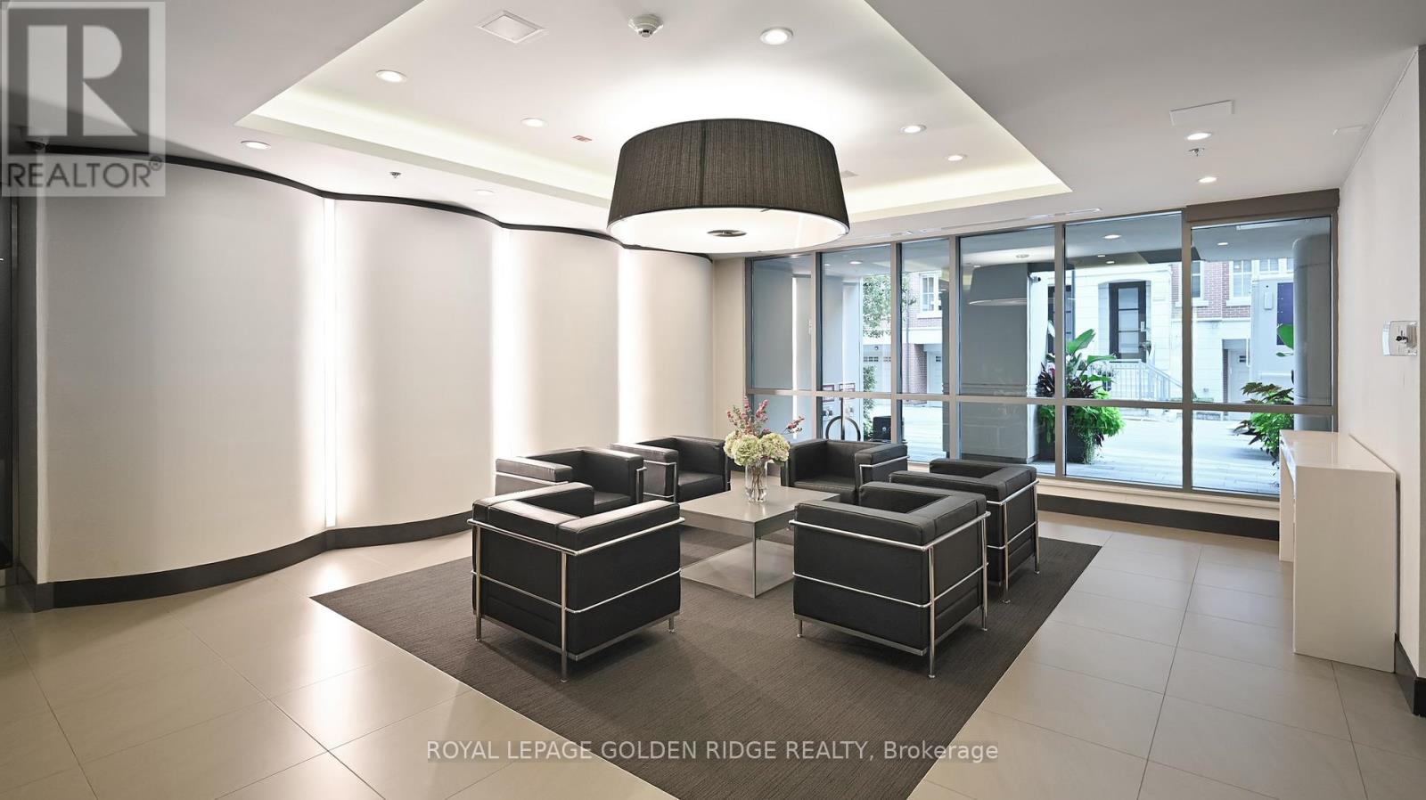 A modern living room with a black and white color scheme.